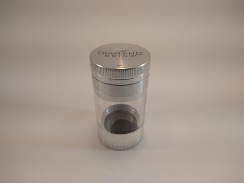 Diamond Shaker 56mm Silver grinder with a large glass collection chamber and a screen.